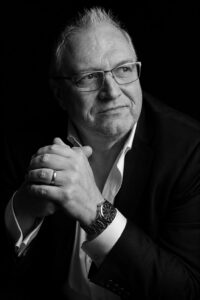 john hopkinson in black jacket and white shirt